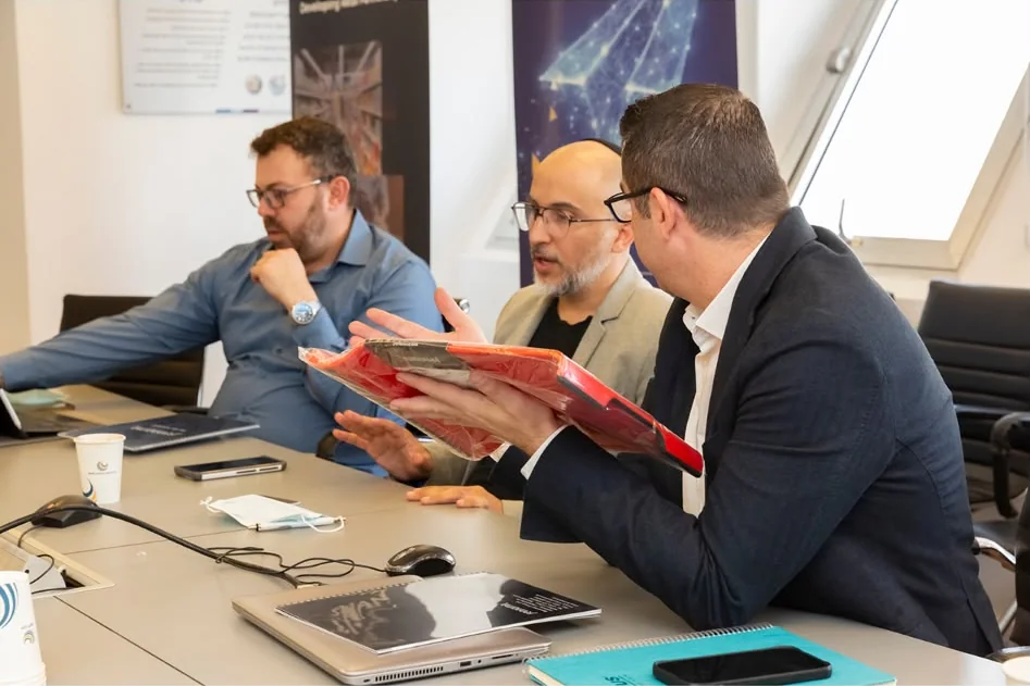 Business meeting where a product sample is presented to a buyer
